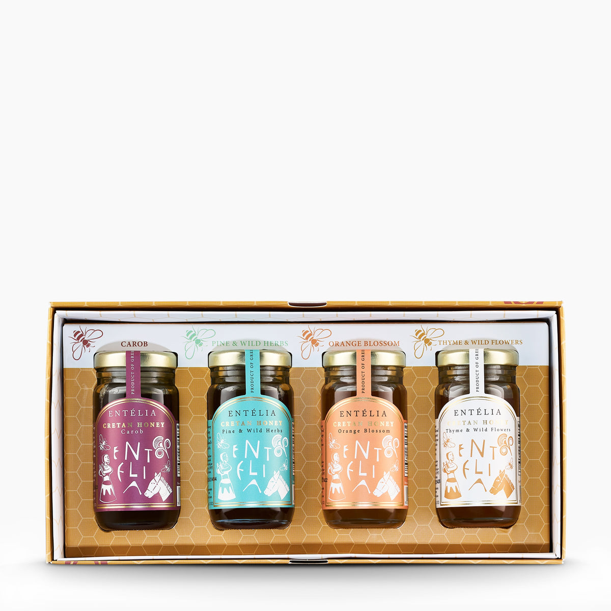 Open Entelia gift box with four 100 g Cretan honeys: Carob, Pine, Orange Blossom, and Thyme varieties.