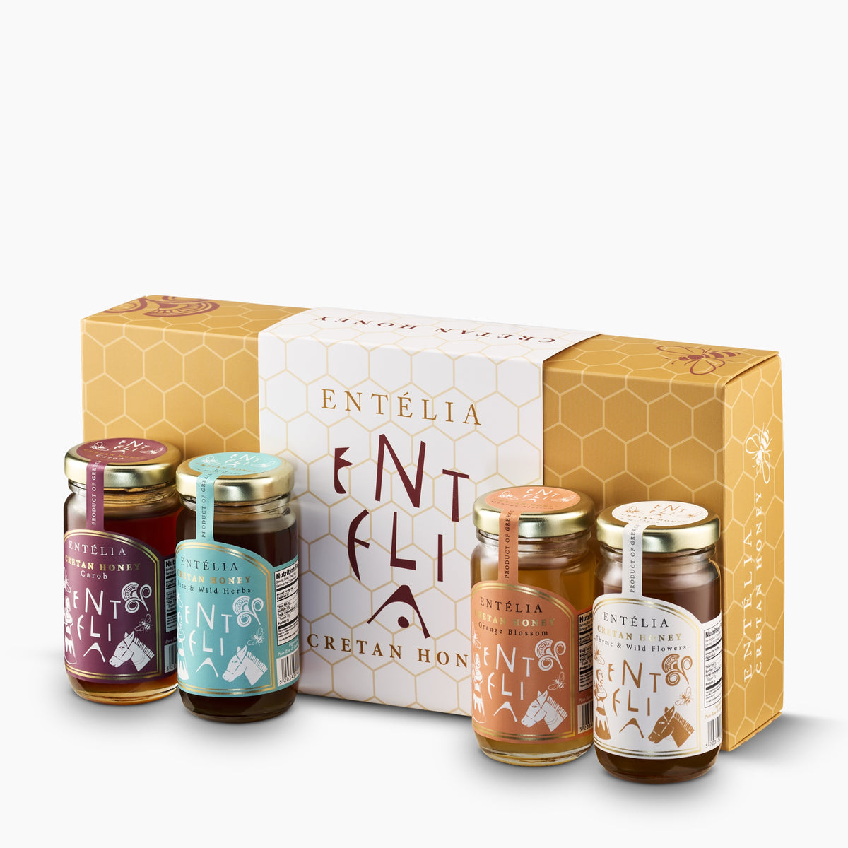 Four 100 g Entelia Cretan honeys; Carob, Pine & Wild Herbs, Orange Blossom, and Thyme & Wild Flowers, with gift box.