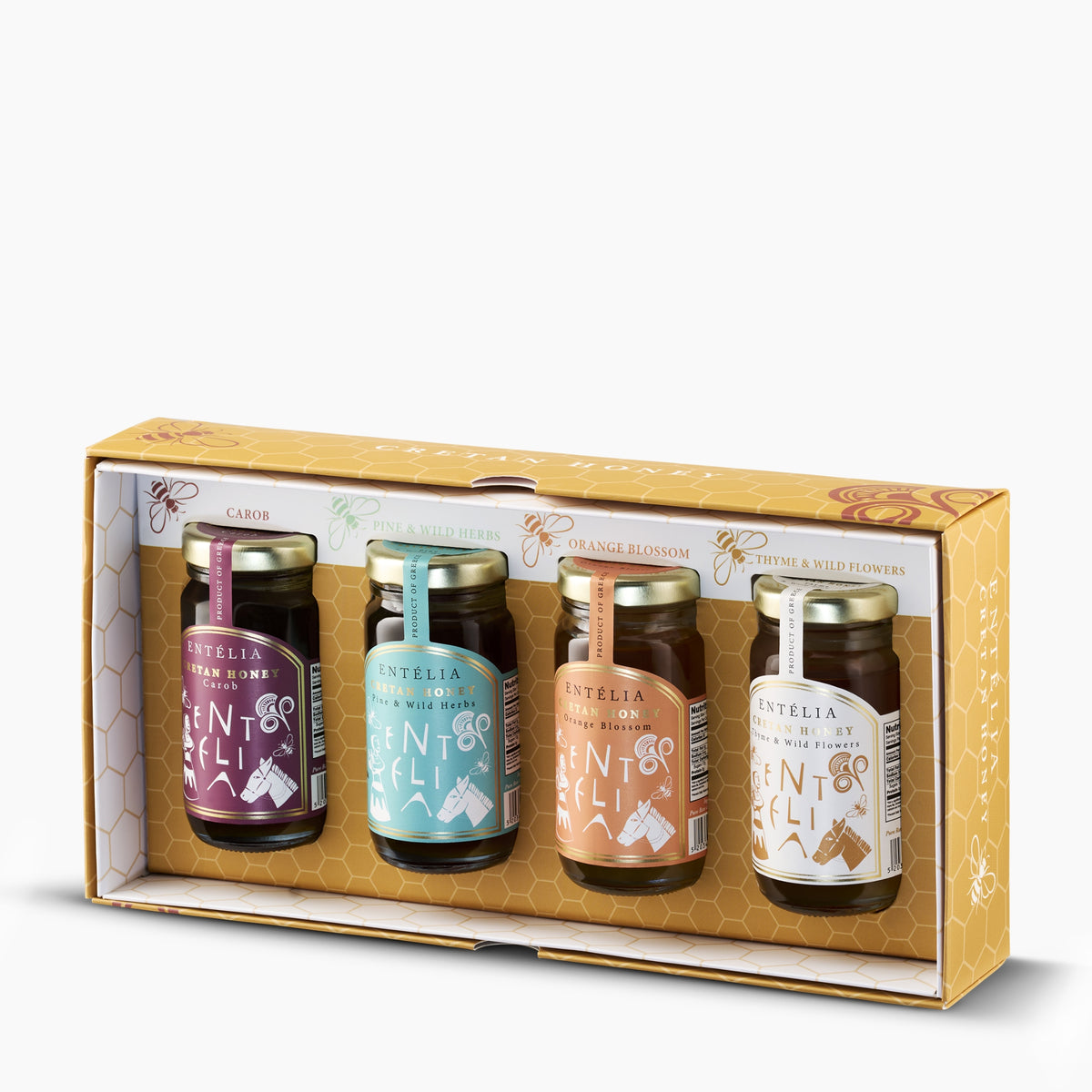 Open Entelia gift box with four 100 g jars of Cretan honeys; Carob, Pine & Wild Herbs, Orange Blossom, and Thyme & Wild Flowers.