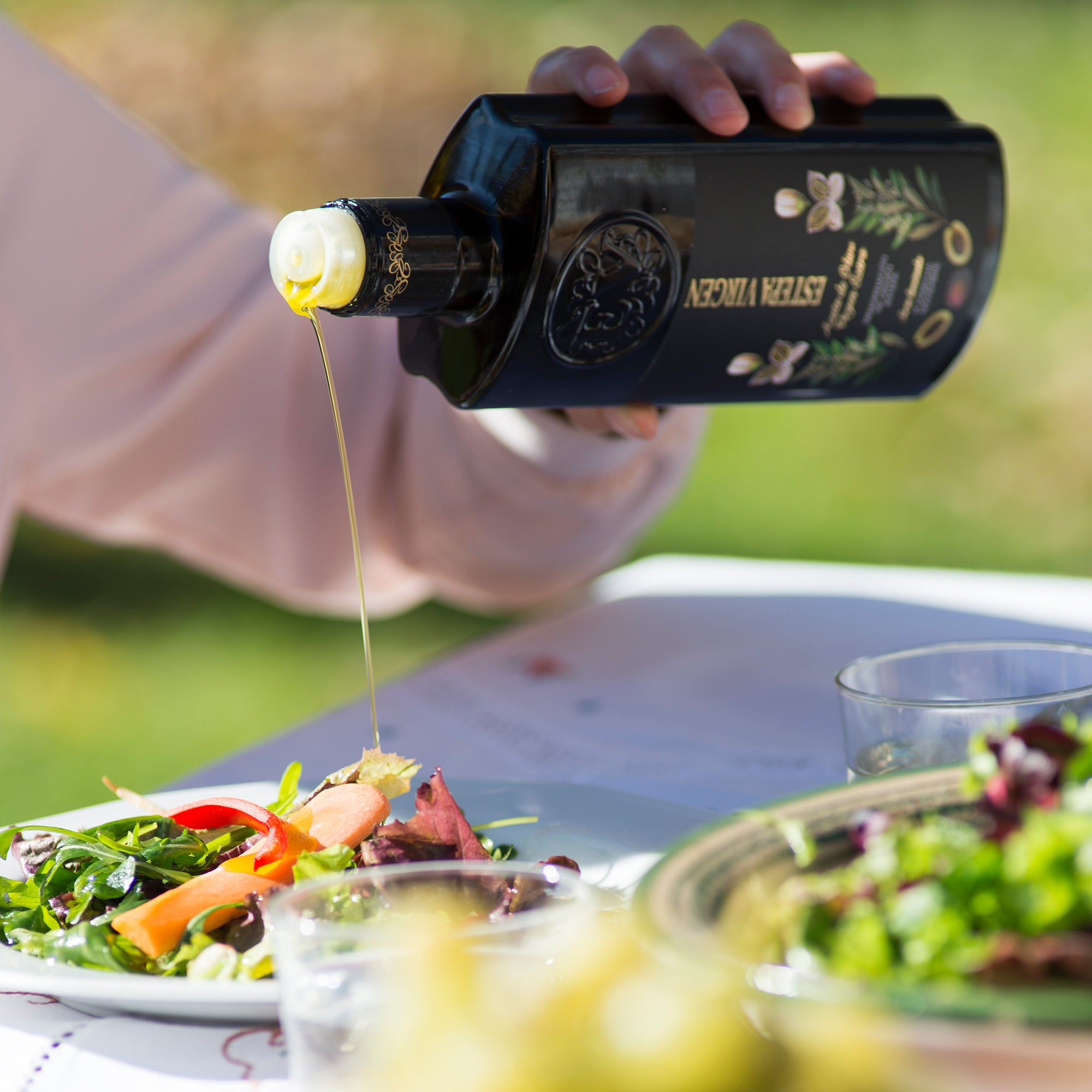 Pouring premium Spanish extra virgin olive oil over garden vegetables, capturing vibrant gastronomy.