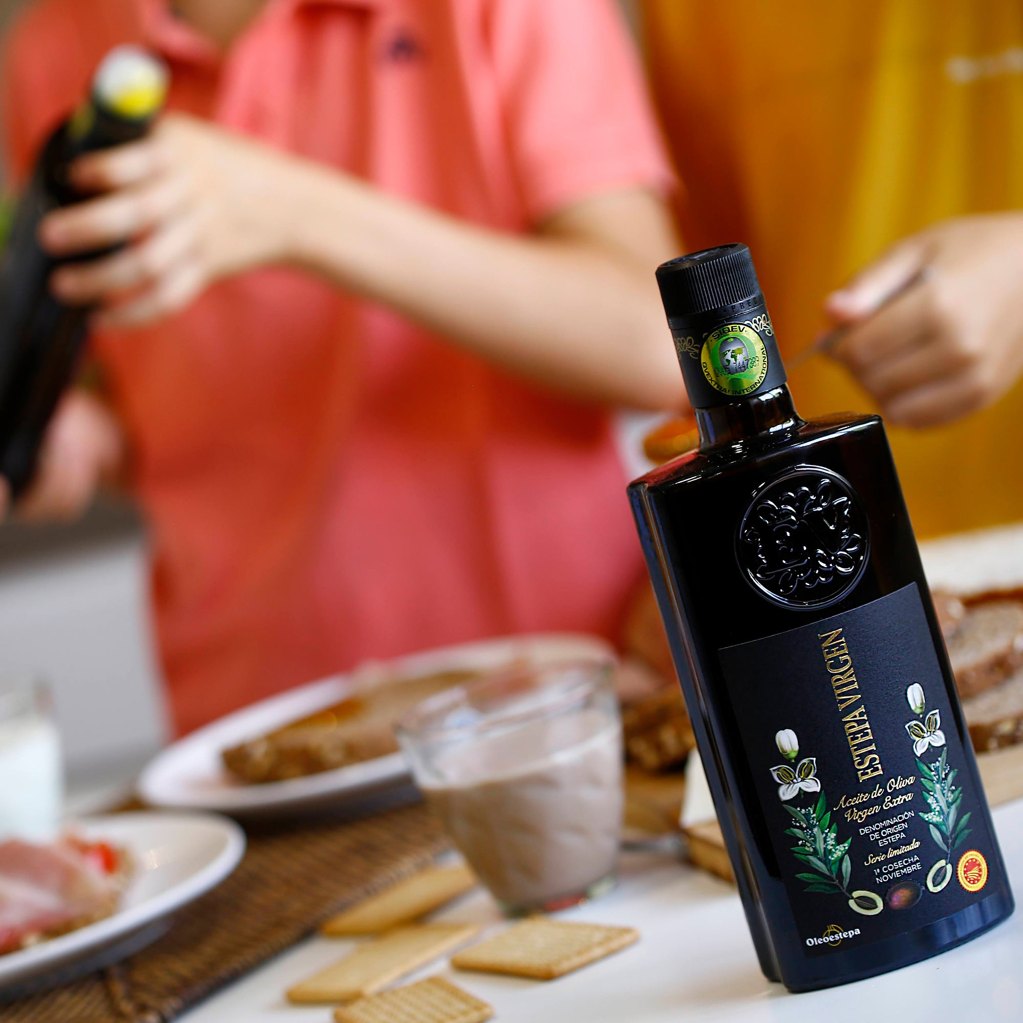 500 ml bottle of Oleoestepa Estepa Virgen extra virgin olive oil accompanying a lunch setting.