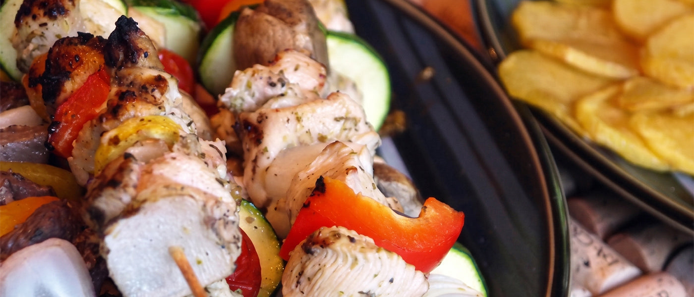 Grilled kebabs with peppers, onions, and golden fried potatoes.