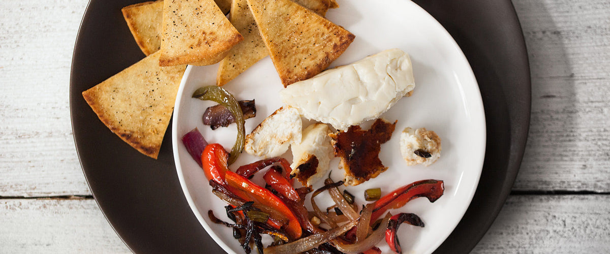Skillet-baked feta with roasted red peppers, onions, and pita chips.