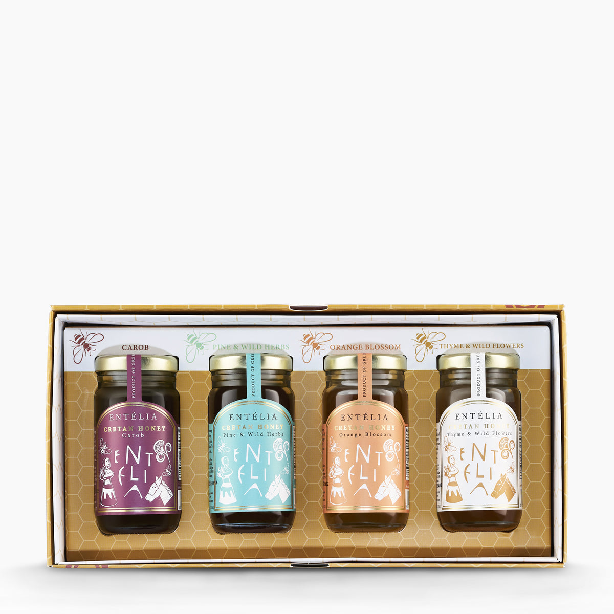 Open Entelia gift box with four 100 g Cretan honeys: Carob, Pine, Orange Blossom, and Thyme varieties.