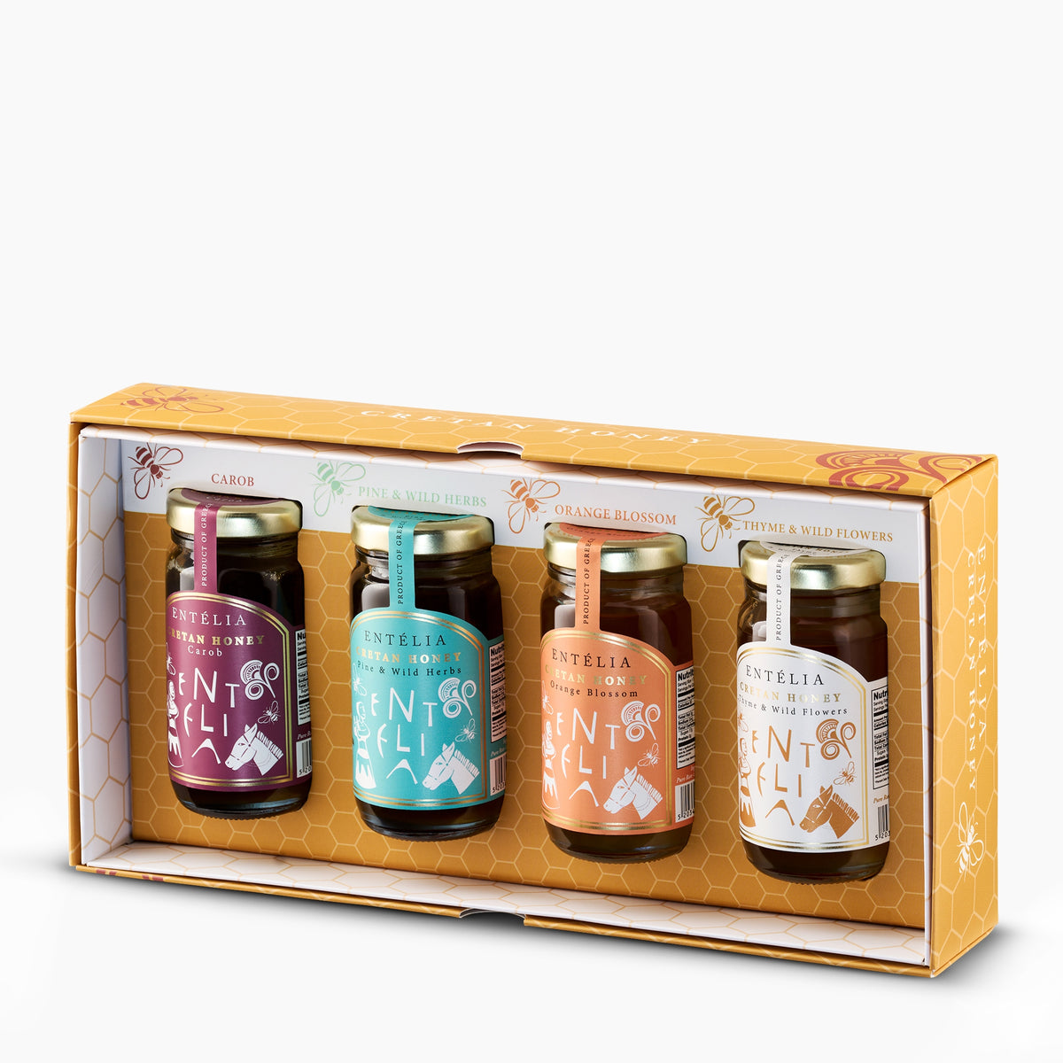 Open Entelia gift box with four 100 g jars of Cretan honeys; Carob, Pine & Wild Herbs, Orange Blossom, and Thyme & Wild Flowers.