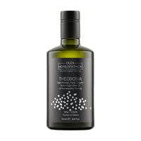 A bottle of Theodosia Homeopathic Koroneiki extra virgin olive oil with a black label.