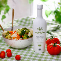 Healthy Mediterranean cuisine with Oleoestepa Egregio Organic extra virgin olive oil, alongside a fresh vegetable salad.