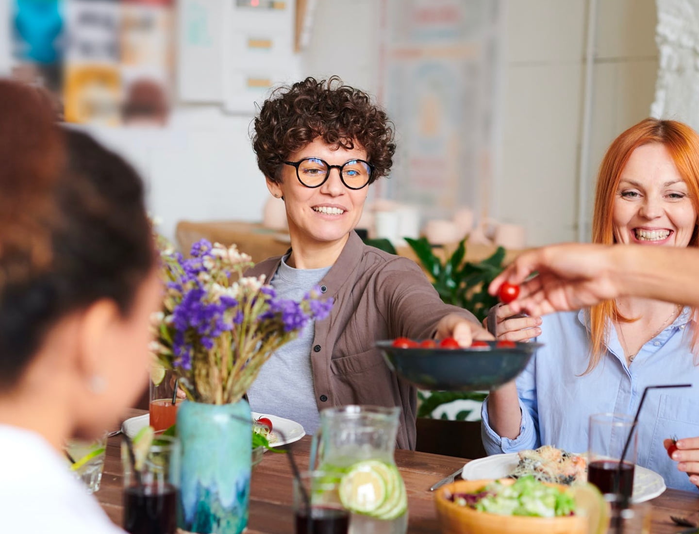 friends enjoying olive oil on fresh salads