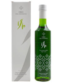 Green bottle of Oro del Desierto olive oil with packaging on a white background