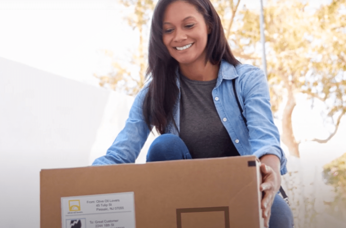 lady smiling as she picks up her free shipping olive oil