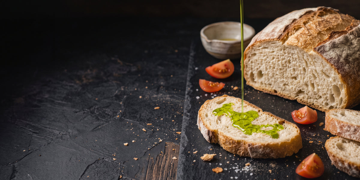 Novello olive oil drizzled over a slice of freshly baked bread.