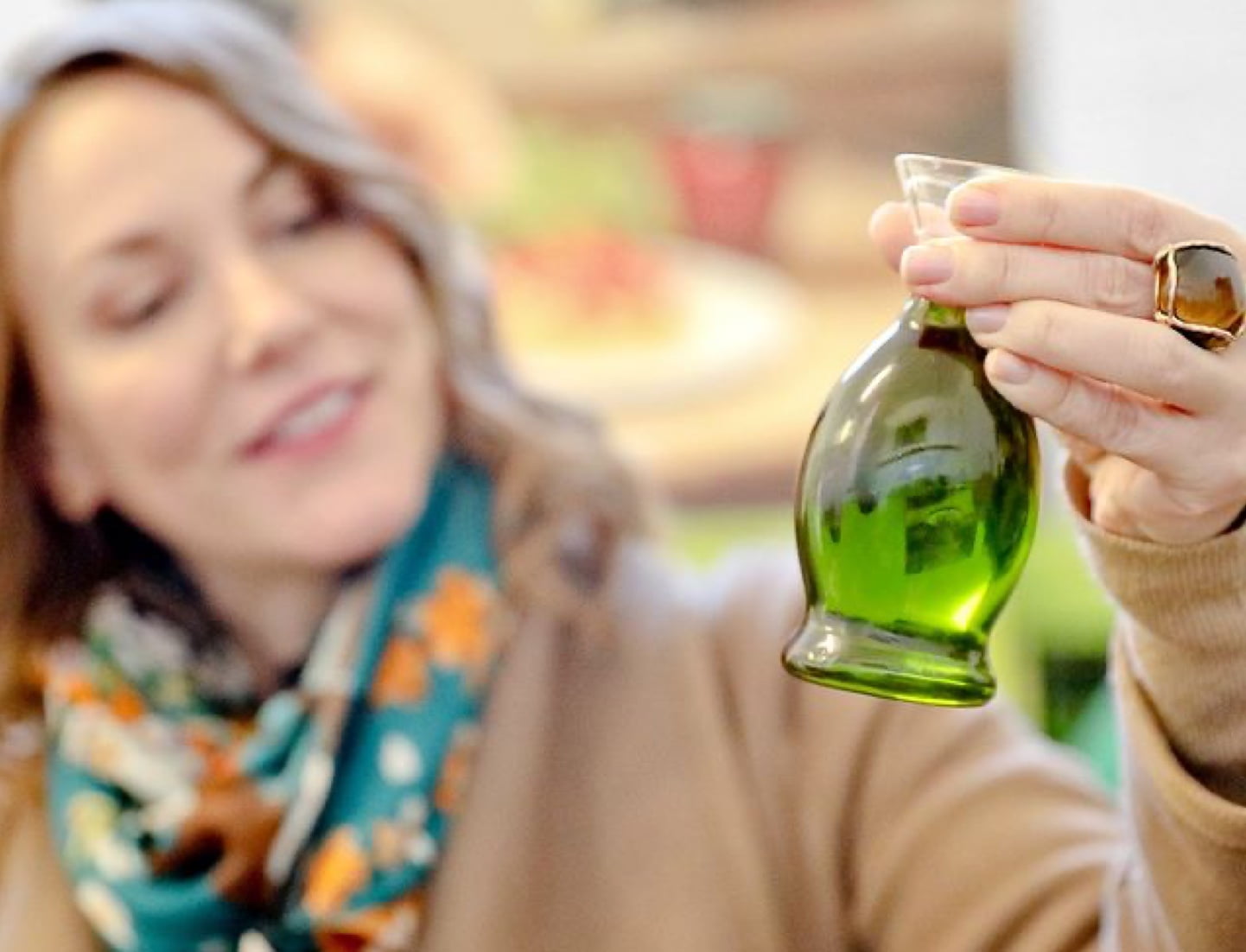 Joanna viewing olive oil in custom bottle