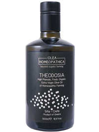 A bottle of Theodosia Homeopathic Koroneiki extra virgin olive oil with a black label and a gift box packaging.